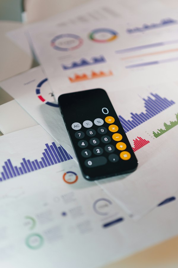 A calculator on printed reports with colourful charts