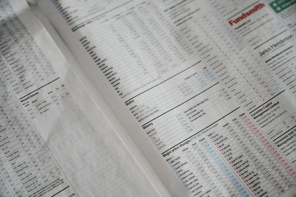 A close-up of printed stock market price tables
