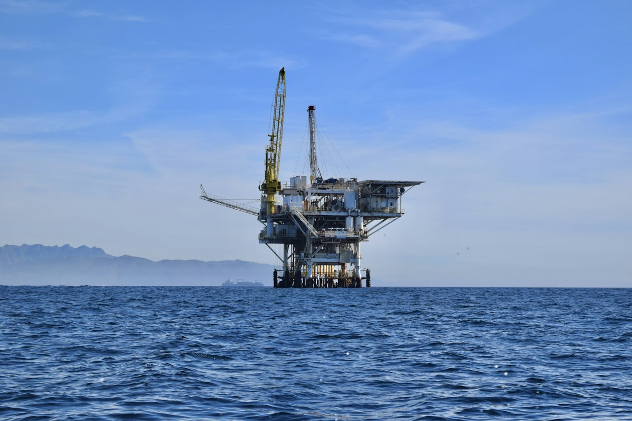 An offshore oil and gas platform in a calm blue sea