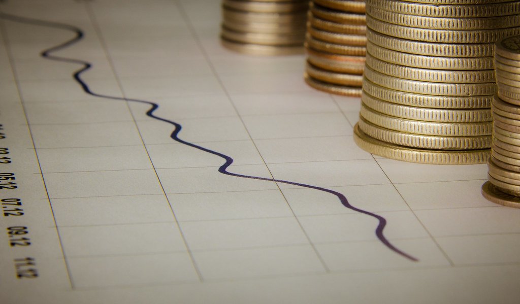 Stacks of coins beside a line graph