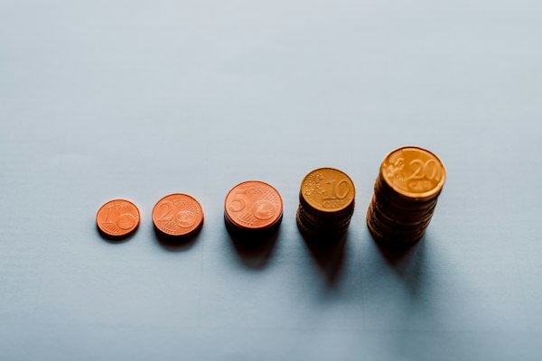 Coins stacked in a row, each stack taller than the last