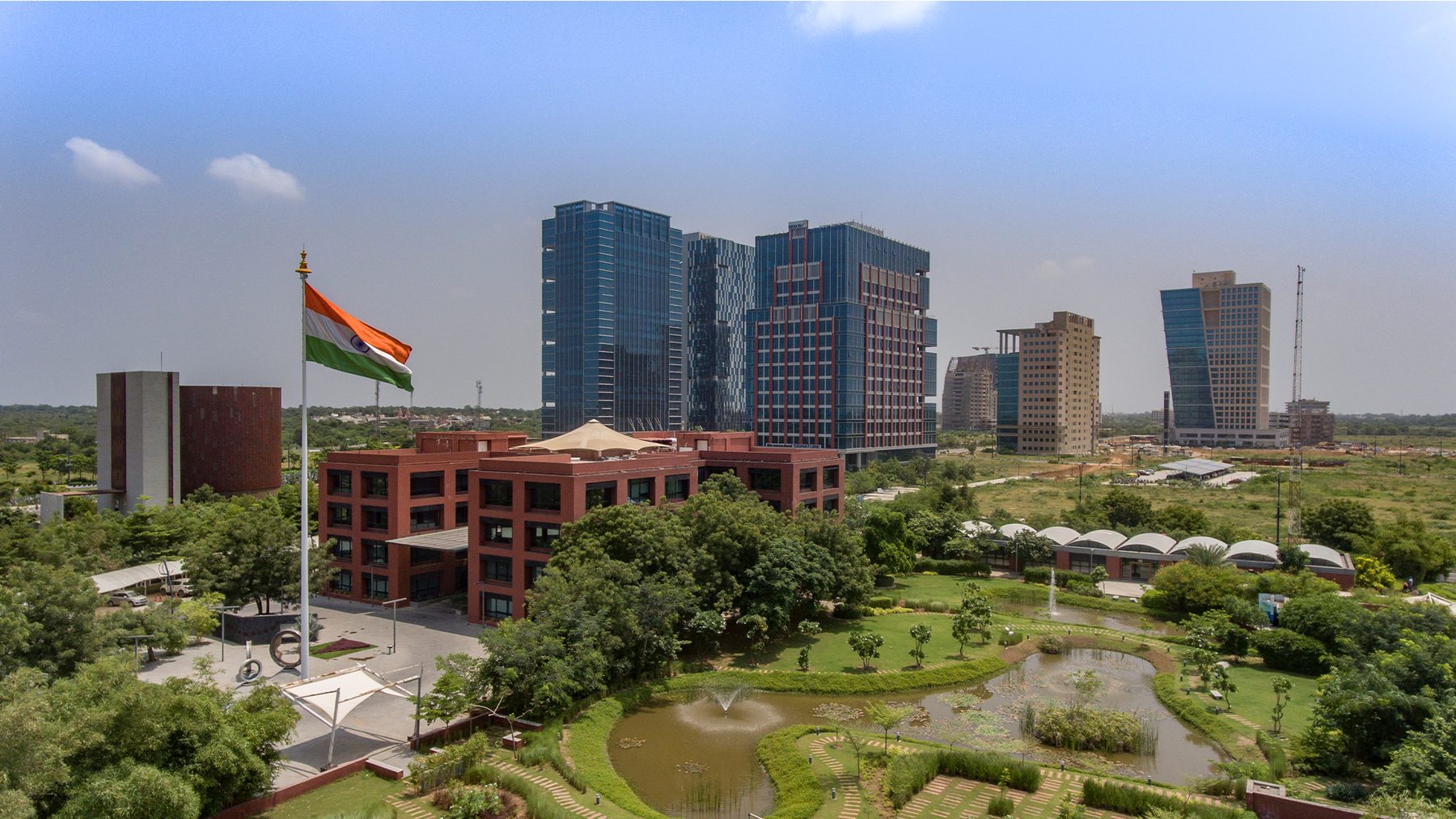 GIFT City, Gandhinagar: glass office towers above landscaped gardens and the Indian flag