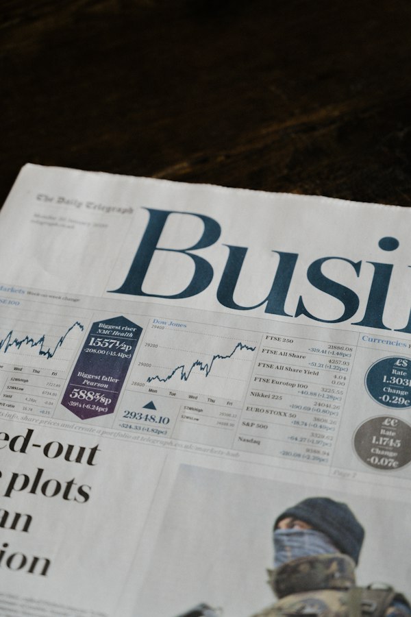 The business pages of a newspaper with stock charts