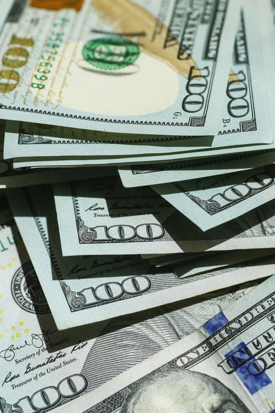 A close-up of stacked US hundred-dollar bills