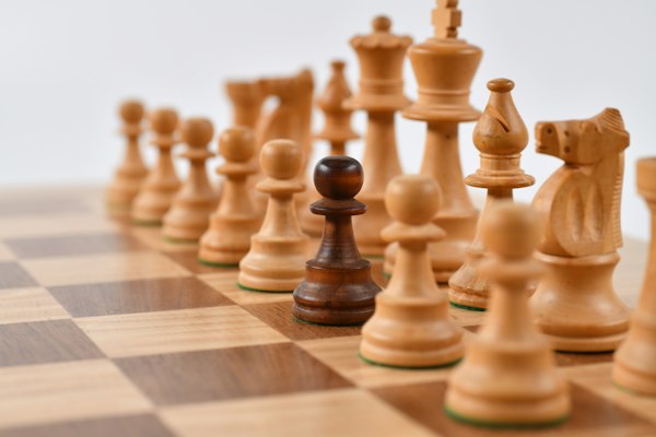 Wooden chess pieces on a chess board